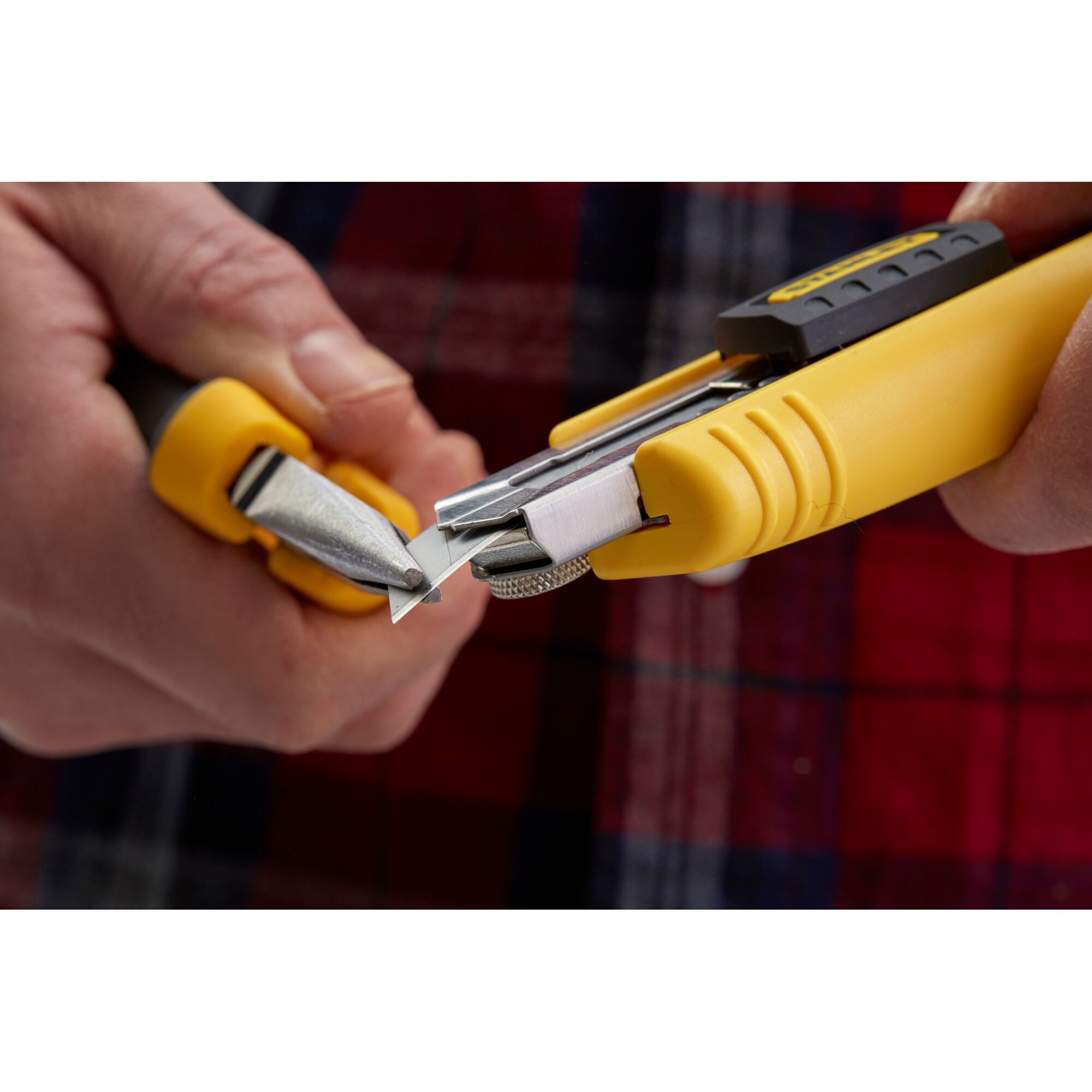 STANLEY 0-10-481 utility knife close-up with yellow handle, blade snapping demonstration.