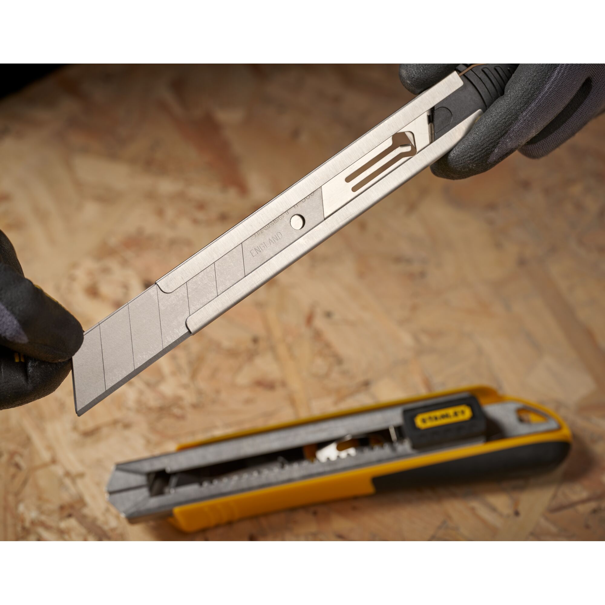 STANLEY 0-11-325 snap-off blade utility knife with segmented replacement blade on work surface.