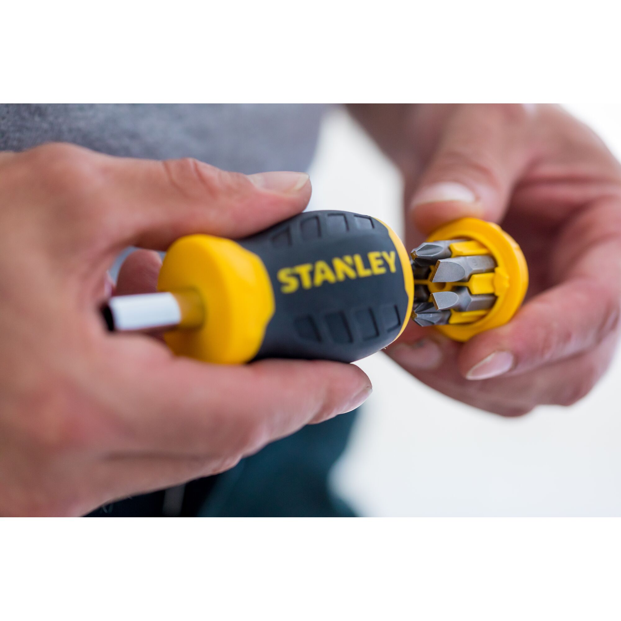 STANLEY 0-66-357 multi-bit screwdriver with yellow and black handle, close-up, showing bit storage in cap.