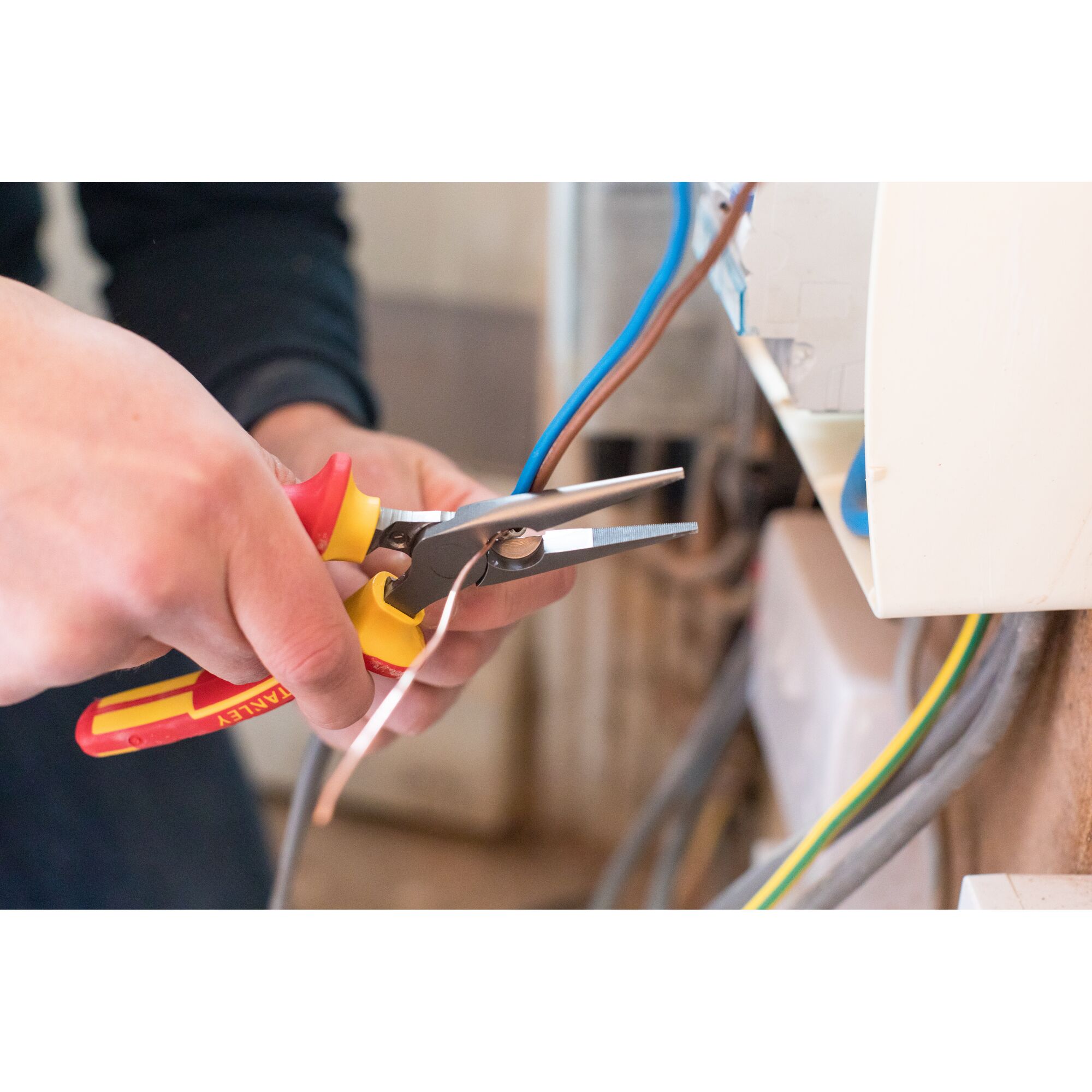Photo of STANLEY 0-84-006 insulated pliers being used to work on electrical wiring.