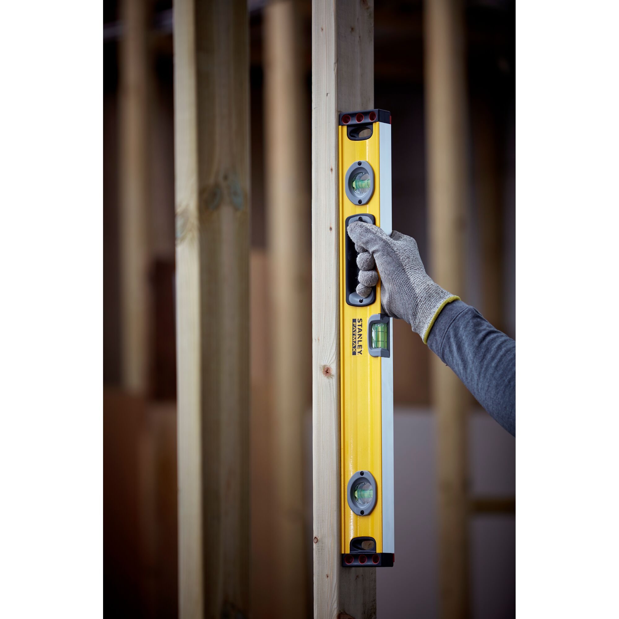 Photo of STANLEY 1-43-524 spirit level being used in vertical position on wood frame.