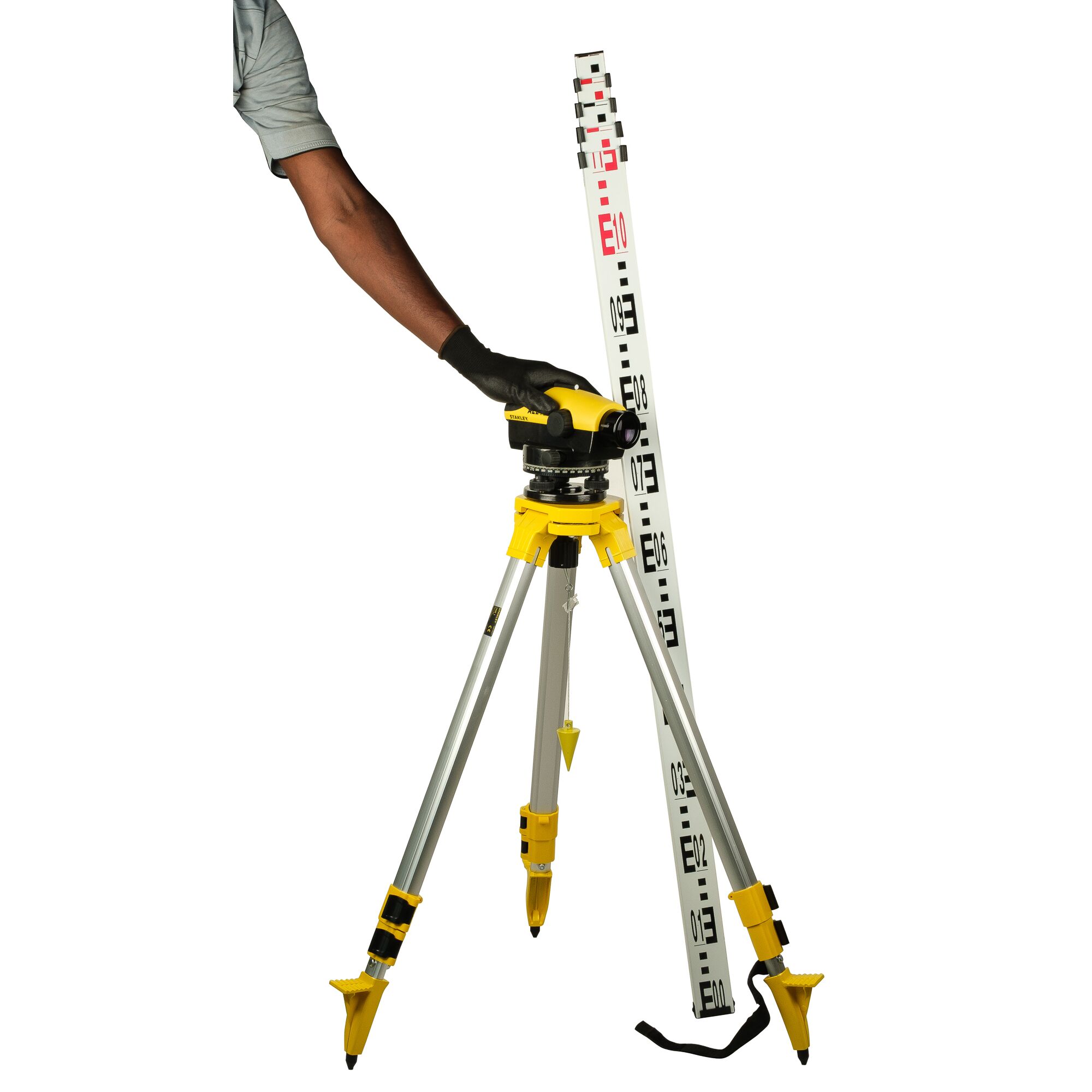 STANLEY 1-77-159N automatic level on tripod with measuring staff, side angle, gloved hand adjusting instrument.