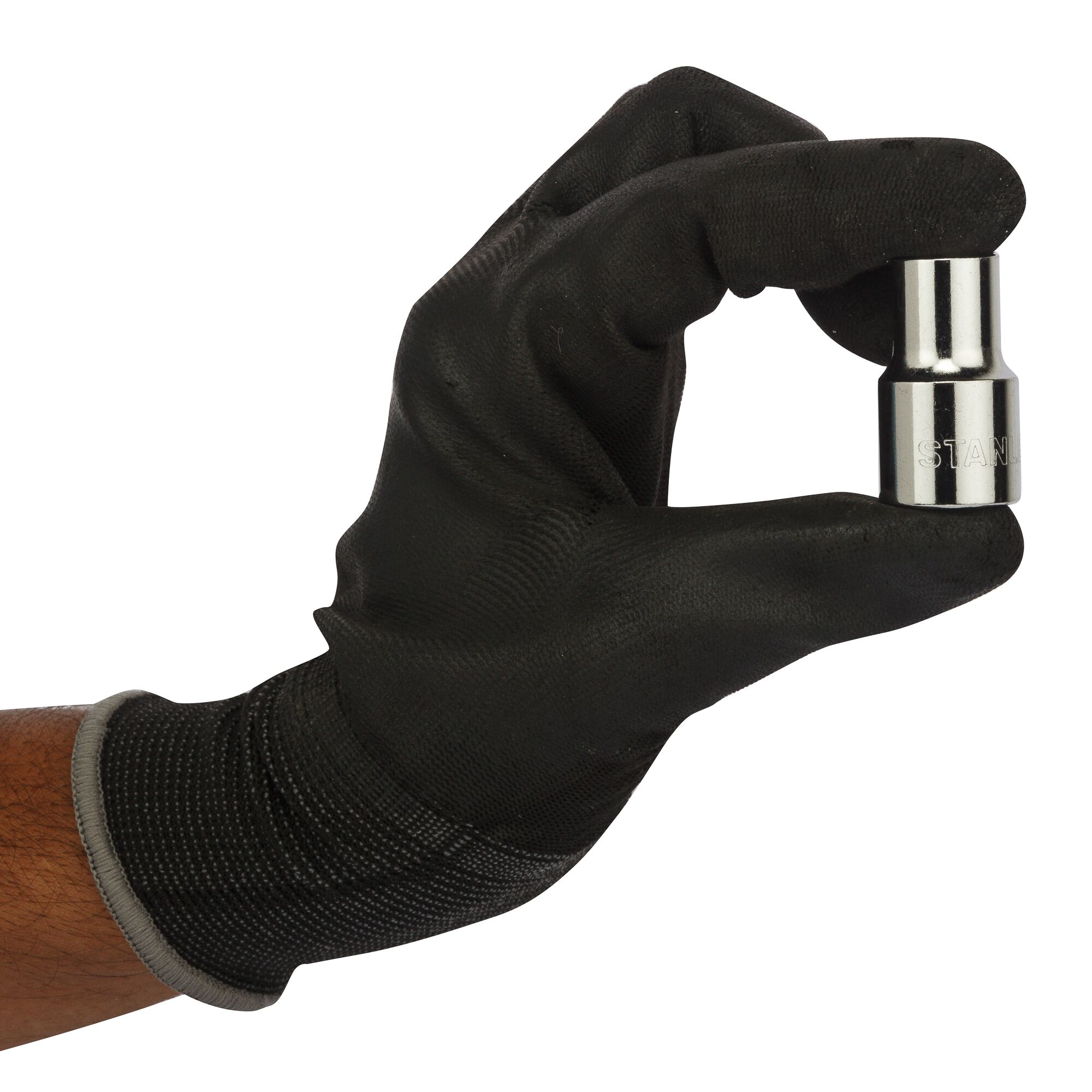 A gloved hand holding a small chrome Stanley socket tool against a white background.