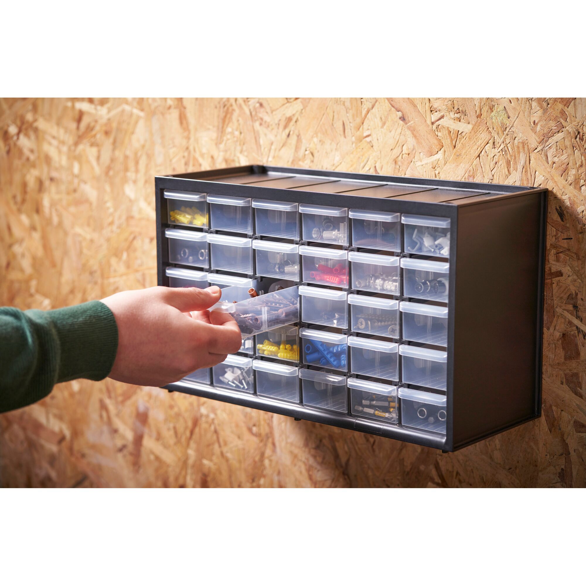 STANLEY 1-93-980 organizer with transparent drawers mounted on wall, hand accessing contents.