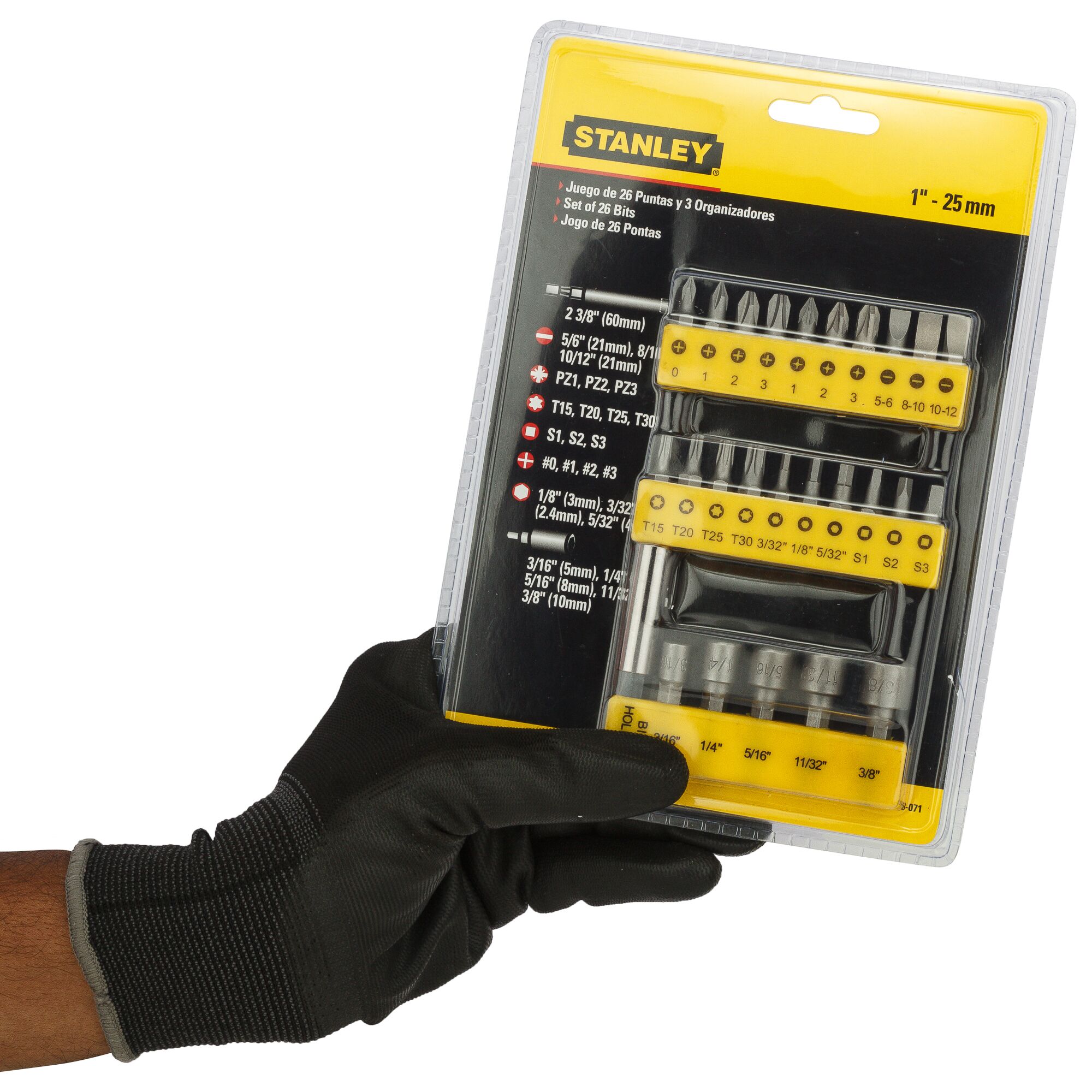 A gloved hand holds a STANLEY 26-piece screwdriver bit set in retail packaging with yellow and black design.