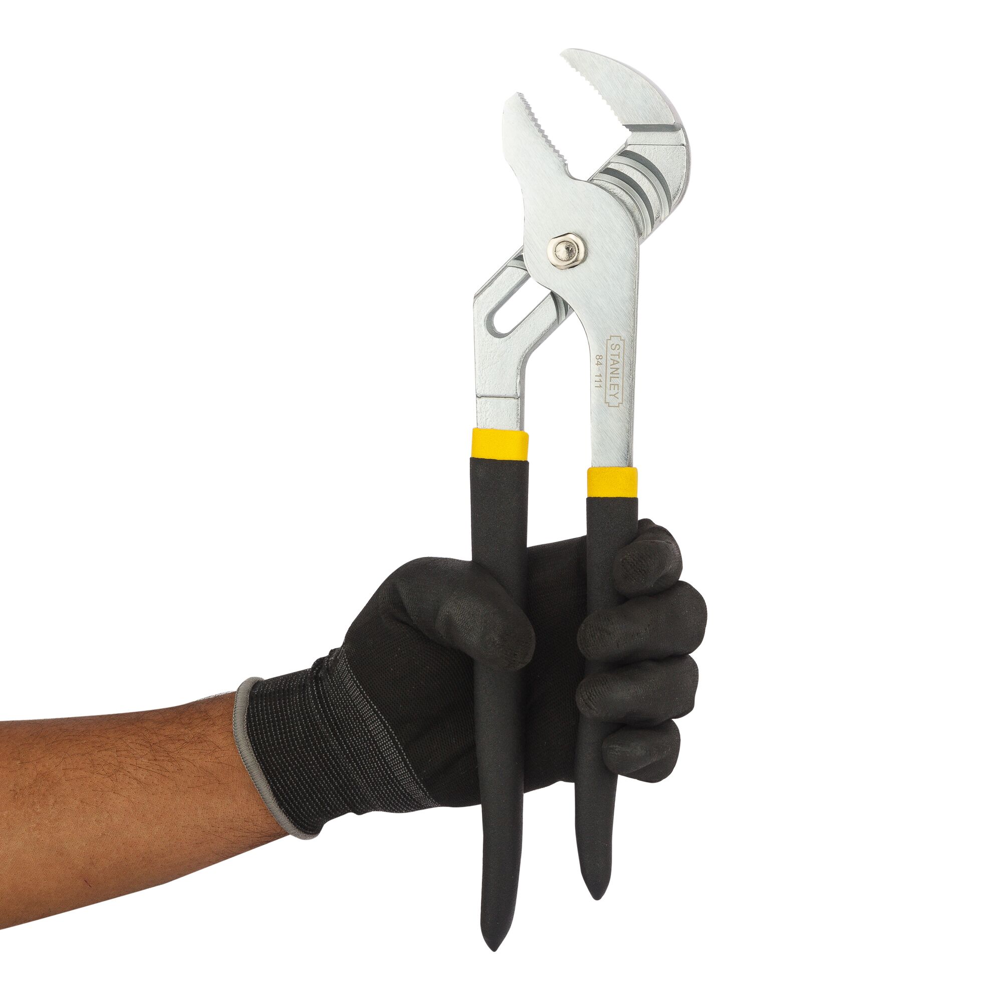 STANLEY 84-111 adjustable pliers with black and yellow handles held in a gloved hand, side angle.