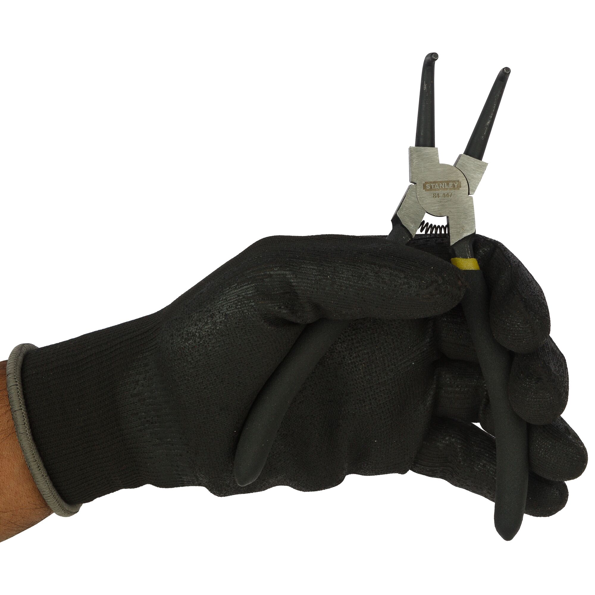 Photo of STANLEY 84-447-23 snap ring pliers held in a gloved hand, showing black handles and metal jaws.