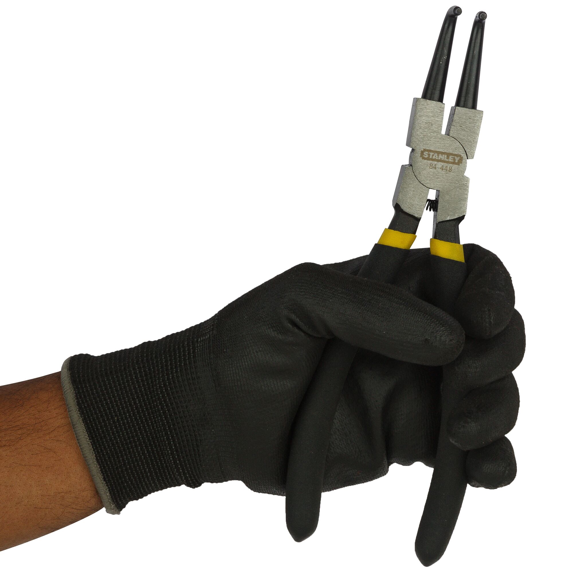 STANLEY 84-448-23 pliers in black gloved hand, close-up angle, showing black handles and silver metal head.