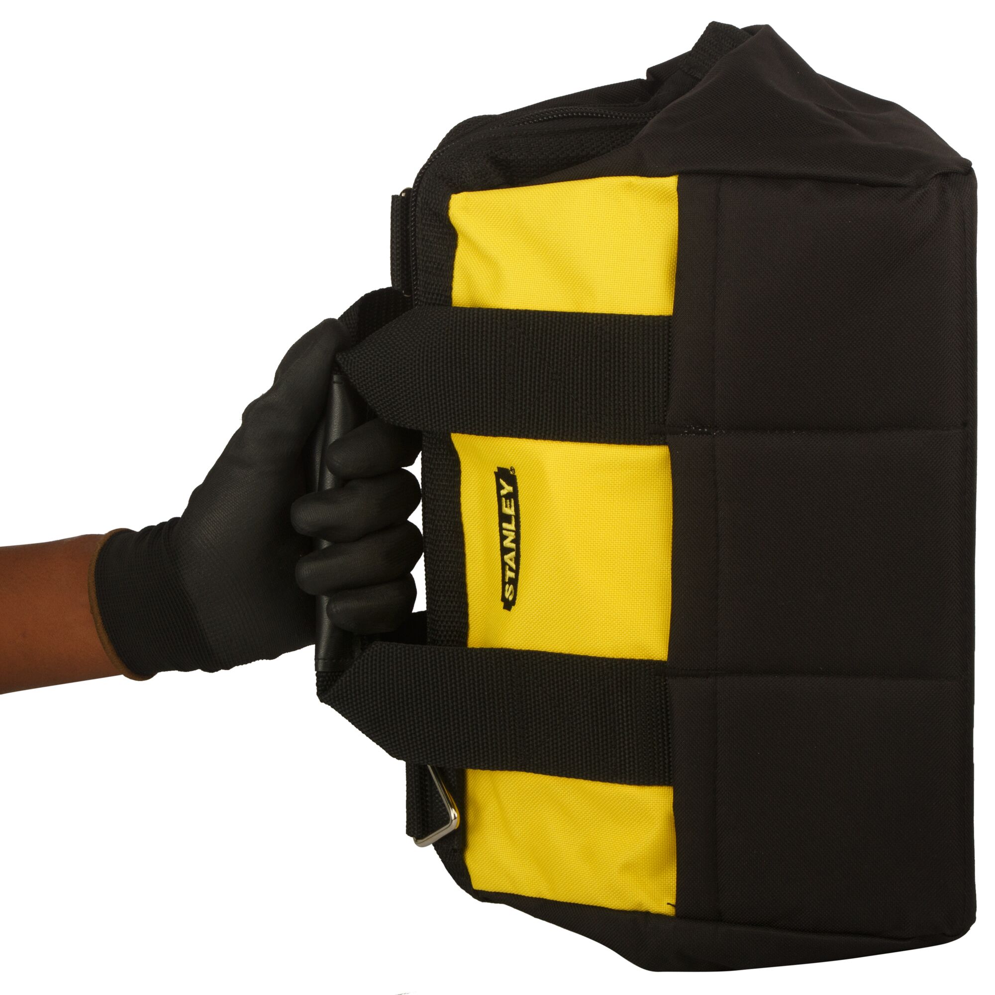 Stanley yellow and black tool bag held by a gloved hand.