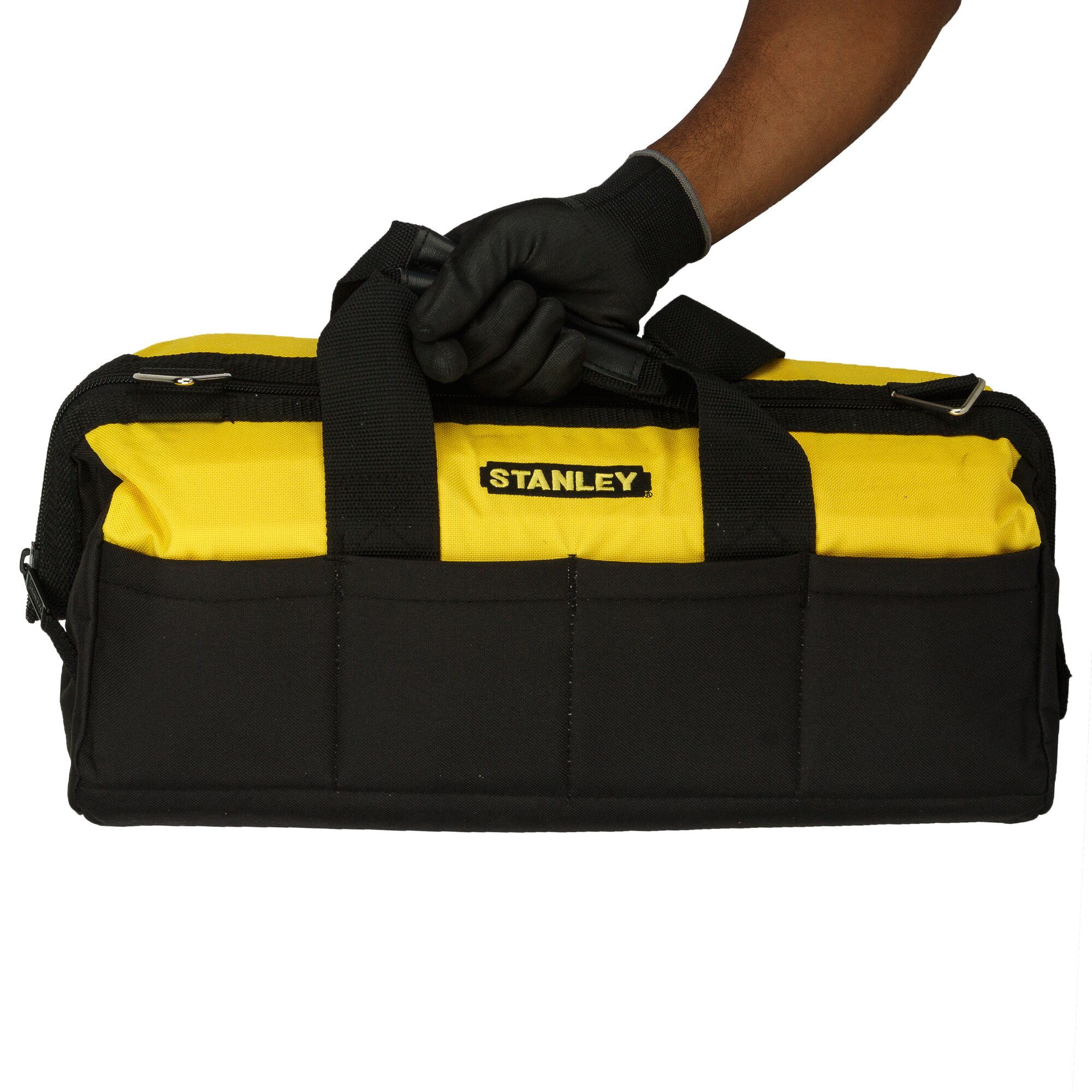 Photo of STANLEY tool bag 93-224, black and yellow, front view, carried by gloved hand.