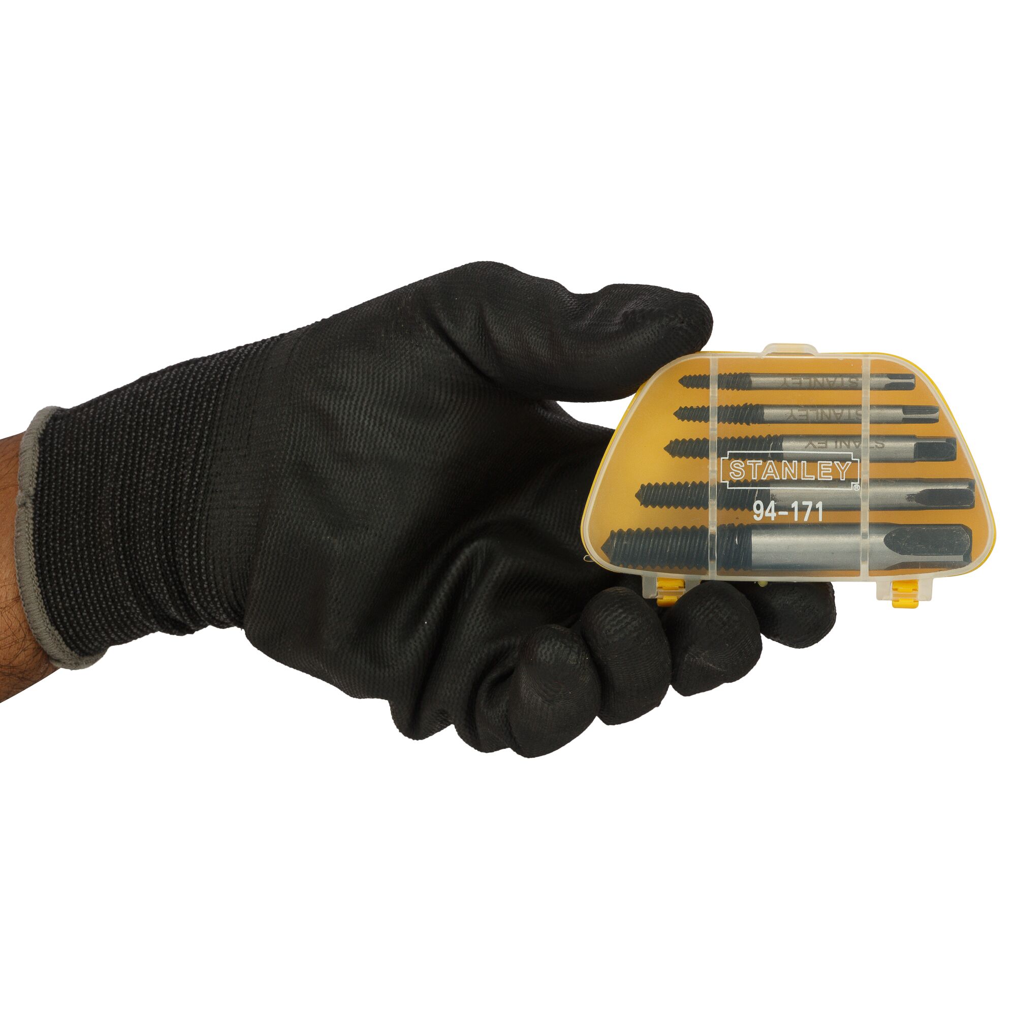Photo of a hand in a black glove holding STANLEY 94-171 screw extractor set in a yellow plastic case, front view.