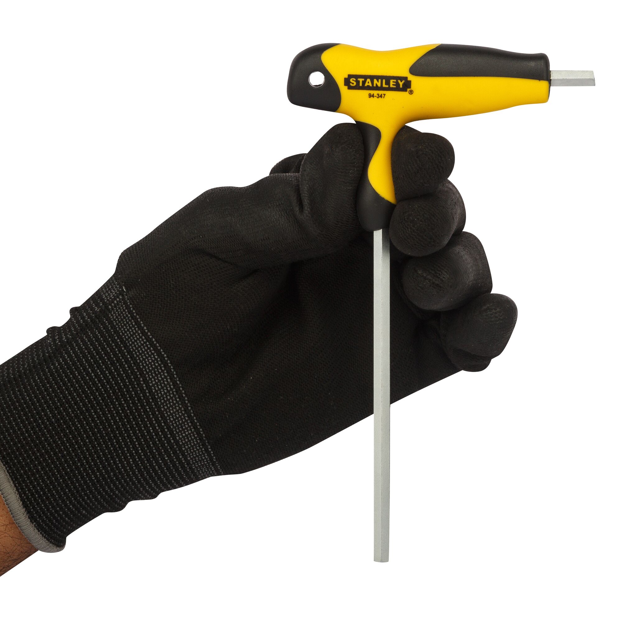 STANLEY 94-347 T-handle hex key held in gloved hand, yellow and black ergonomic design.