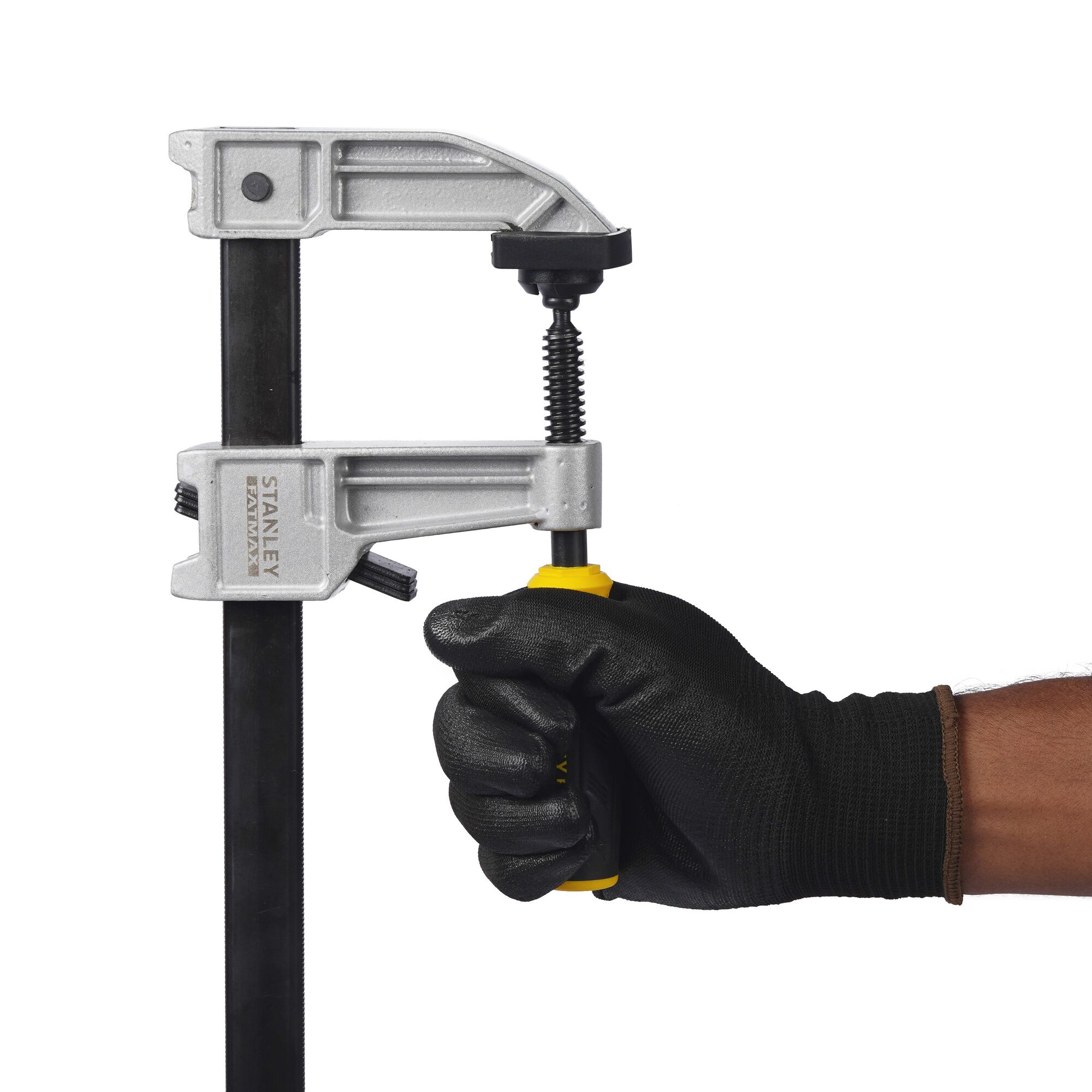 STANLEY FMHT0-83246 photography of F clamp held by gloved hand, side angle on white background.