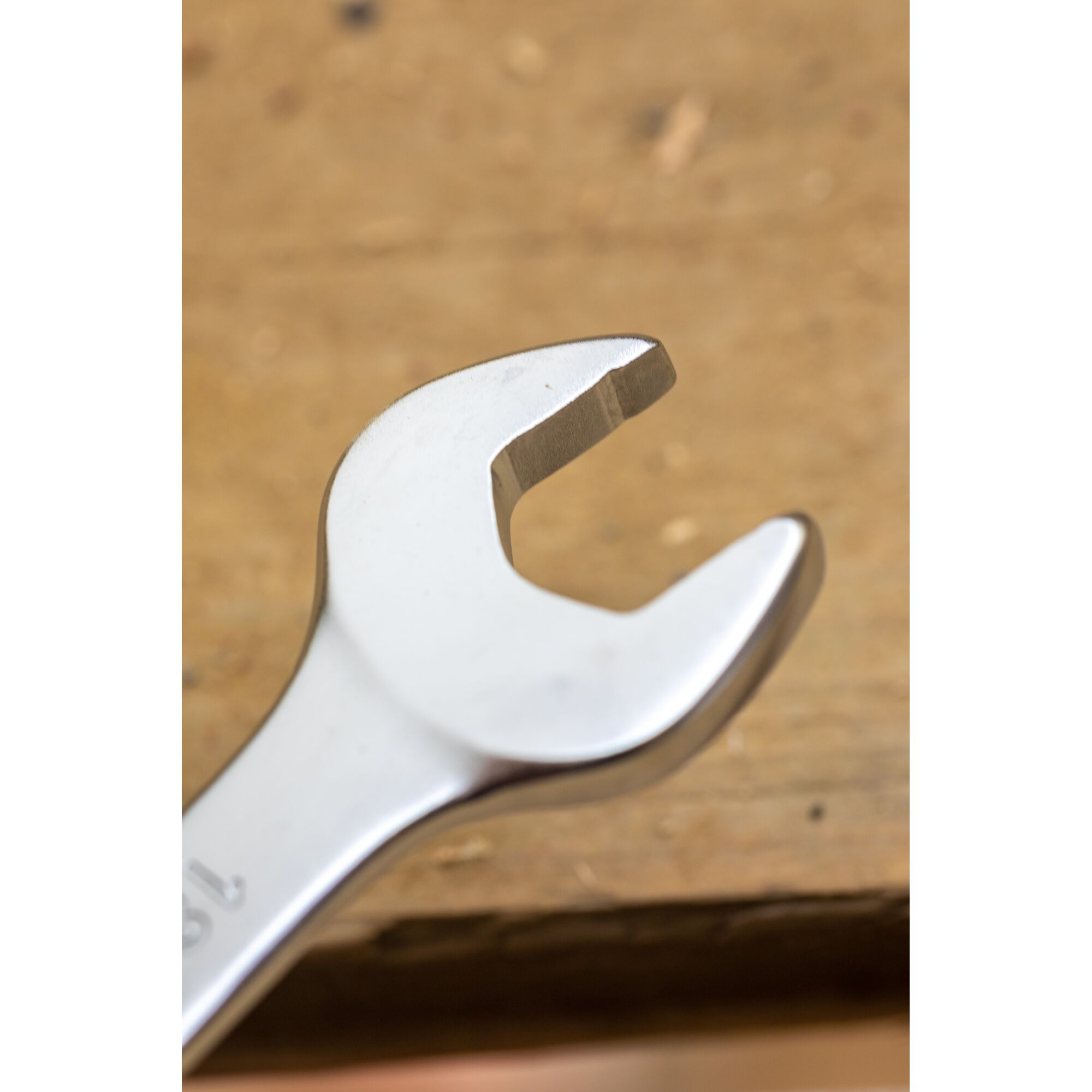 Photo of STANLEY FMMT13089-0 open-end wrench, close-up view, metallic finish, tool on wooden surface.