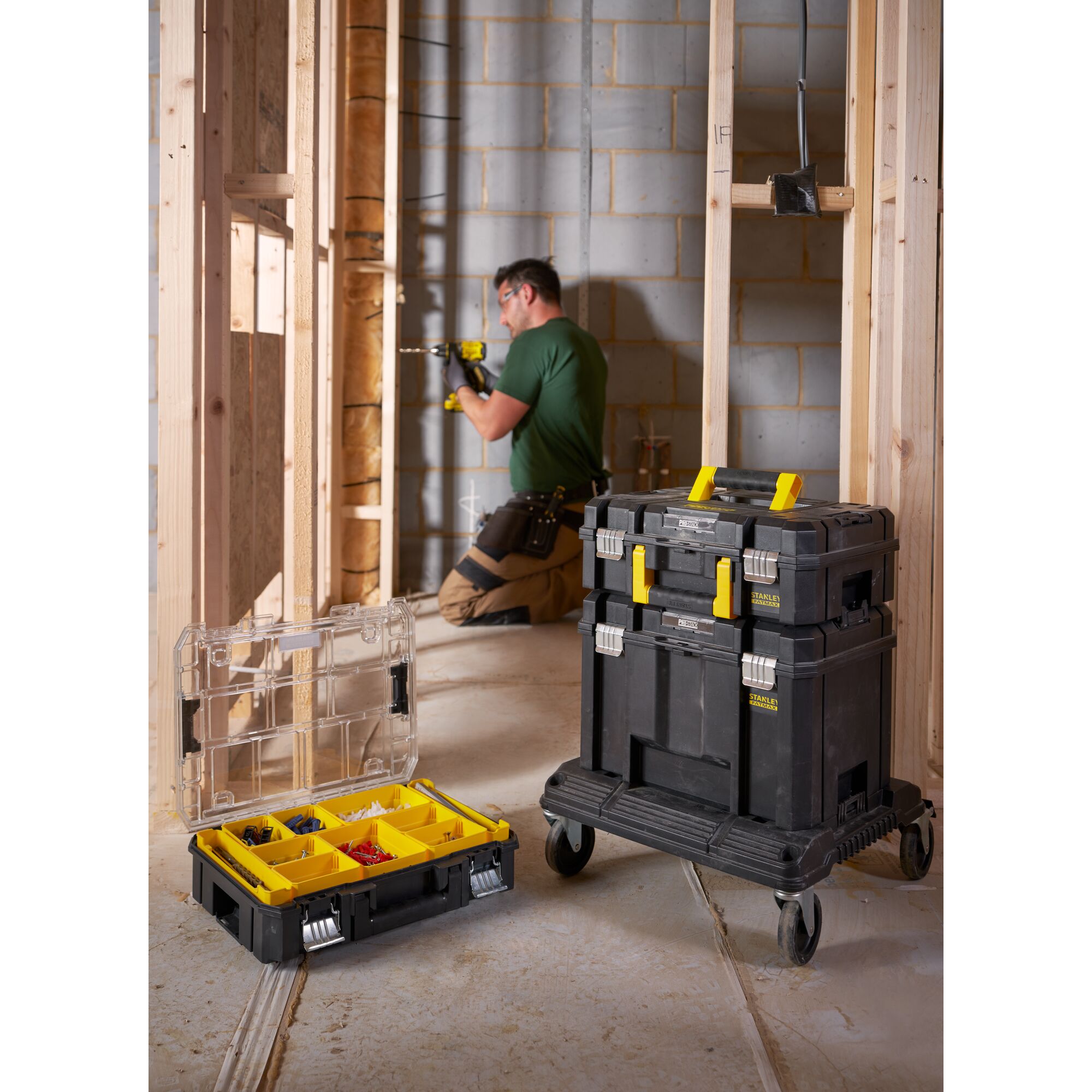 STANLEY FMST1-71966 mobile tool storage stack and organizer box with yellow handles on construction site.
