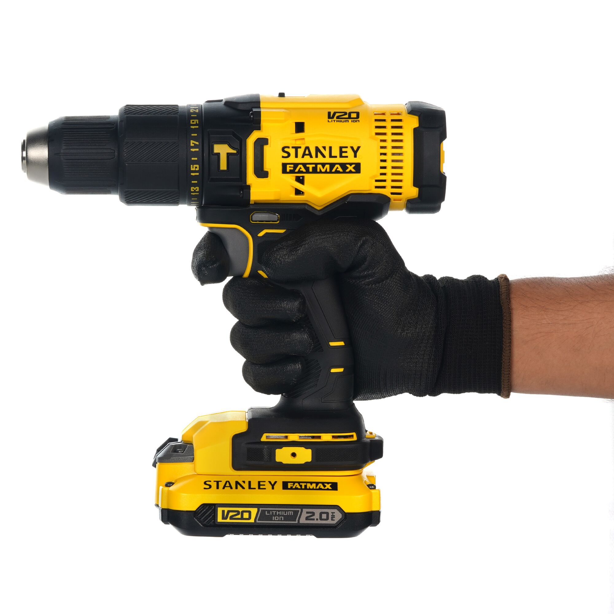 Stanley SCD711D2K cordless drill, yellow and black, side view, held by gloved hand, V20 FATMAX series.