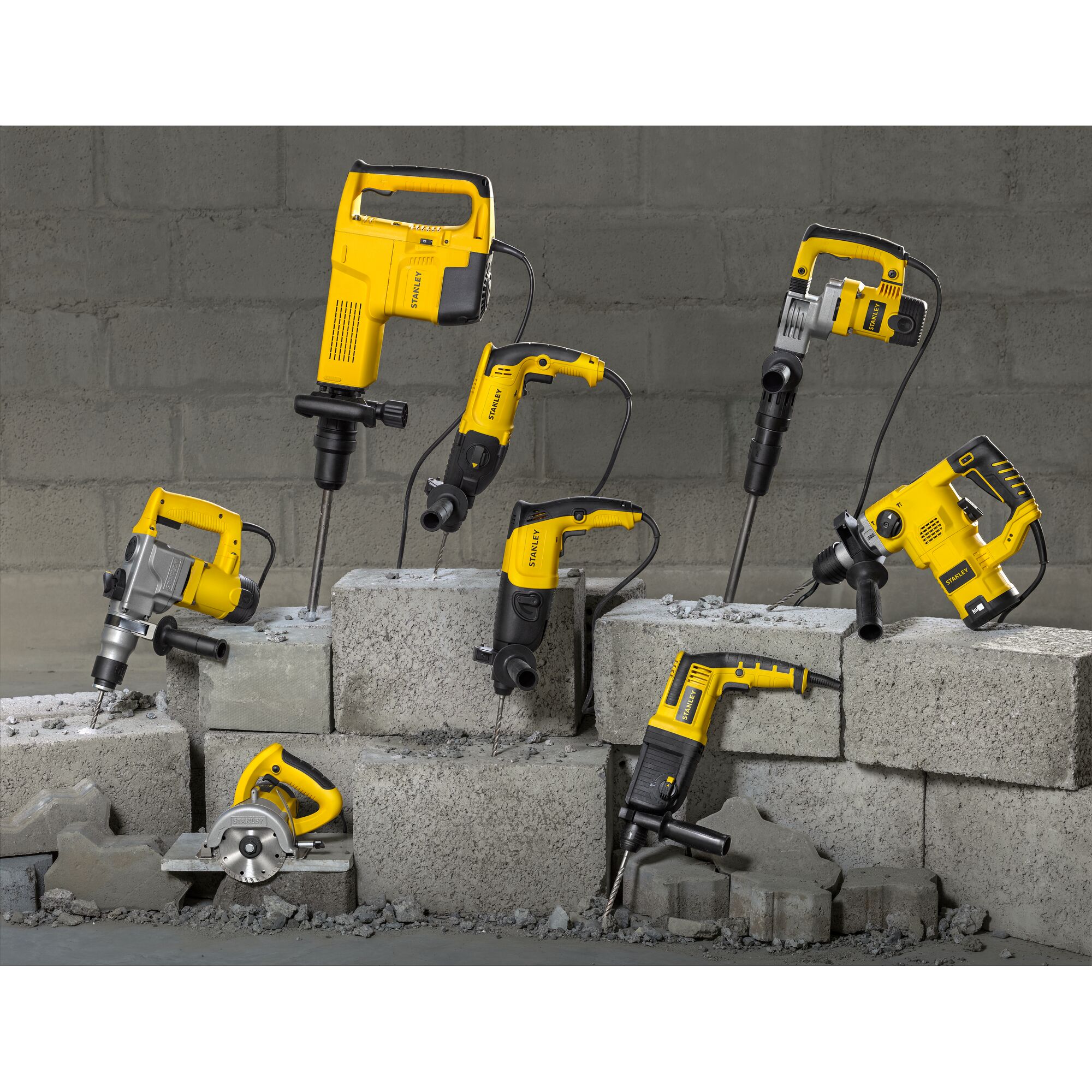 STANLEY SHR263K-BR corded power tools displayed on concrete blocks, front angle, yellow and black design.
