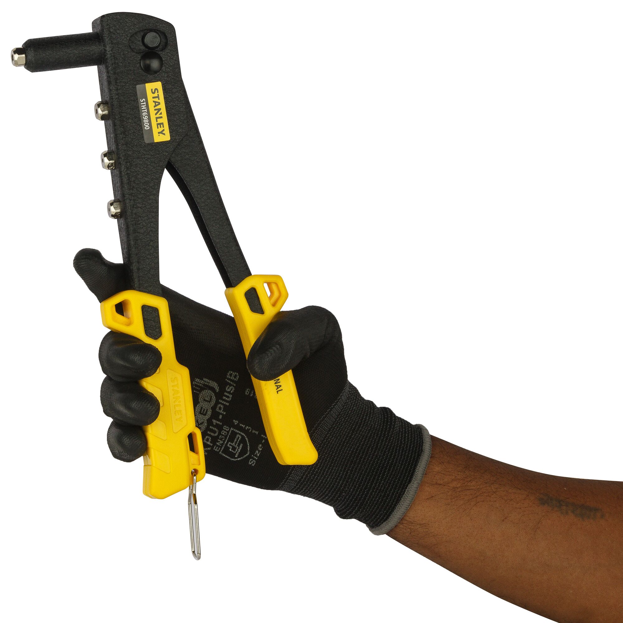 Stanley STHT69800-8 rivet tool with yellow handles held in a gloved hand, side angle, product photography.