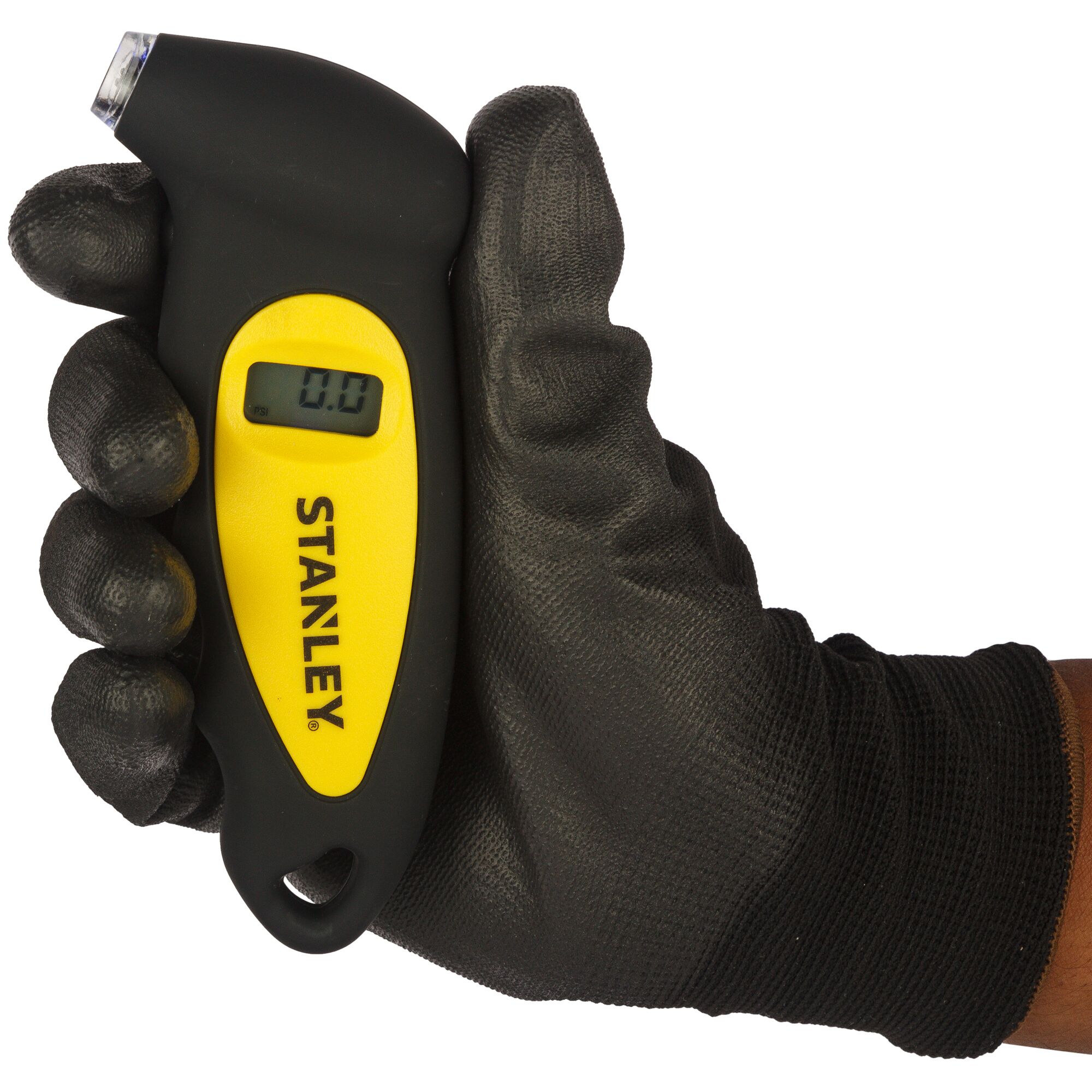 Stanley STHT80874-0 digital tire gauge in black and yellow, held in a gloved hand, front angle.