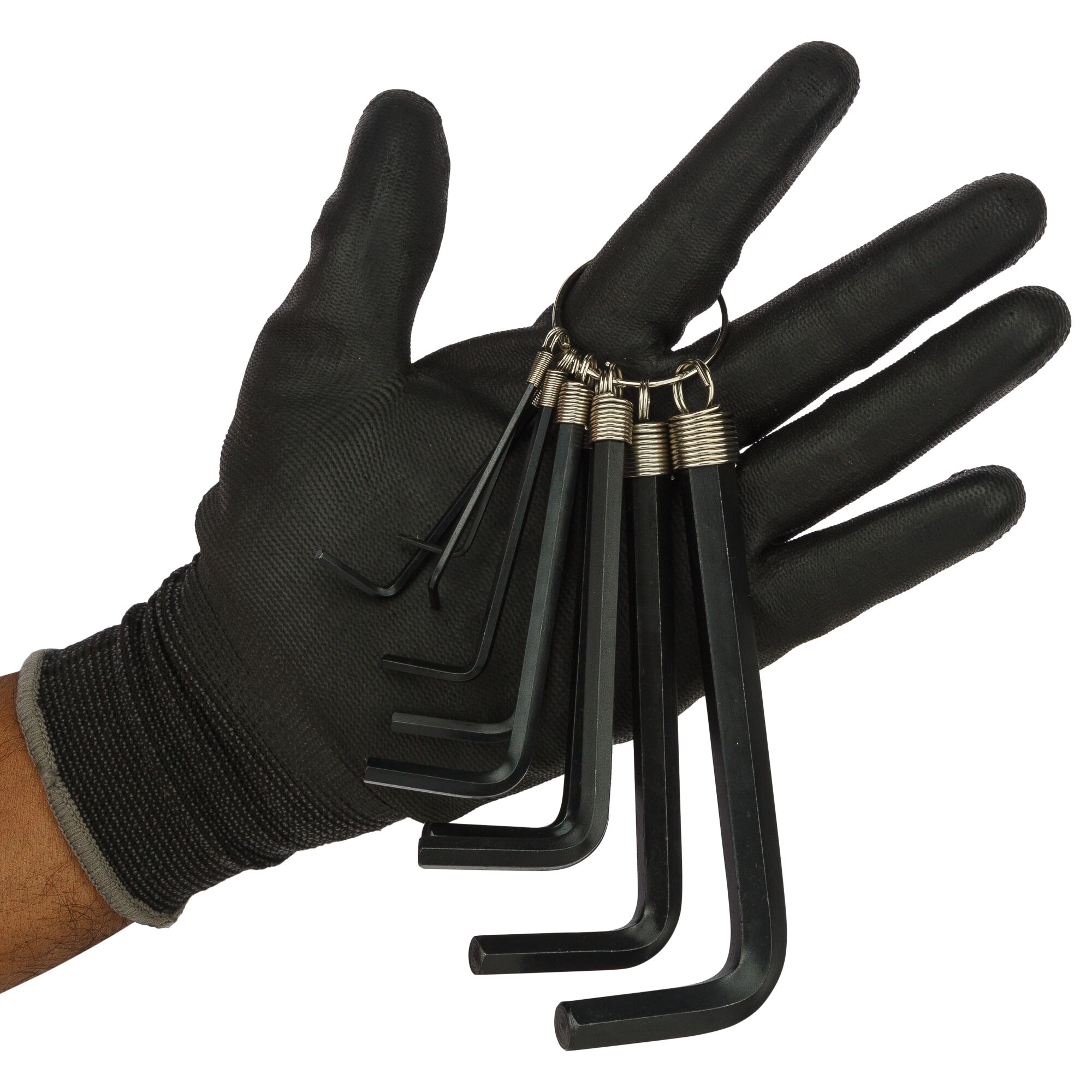 A gloved hand holds a set of black hex keys on a metal ring, showing various sizes.