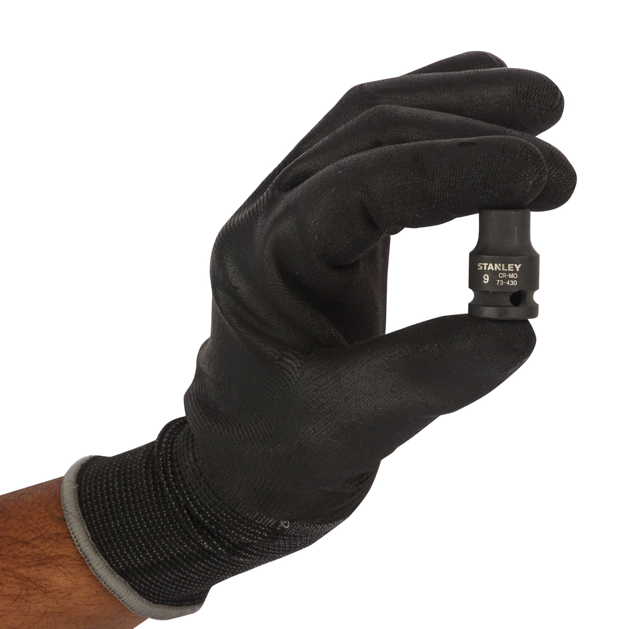 Photo of a hand in a black glove holding a STANLEY STMT73430-8B socket tool against a white background.