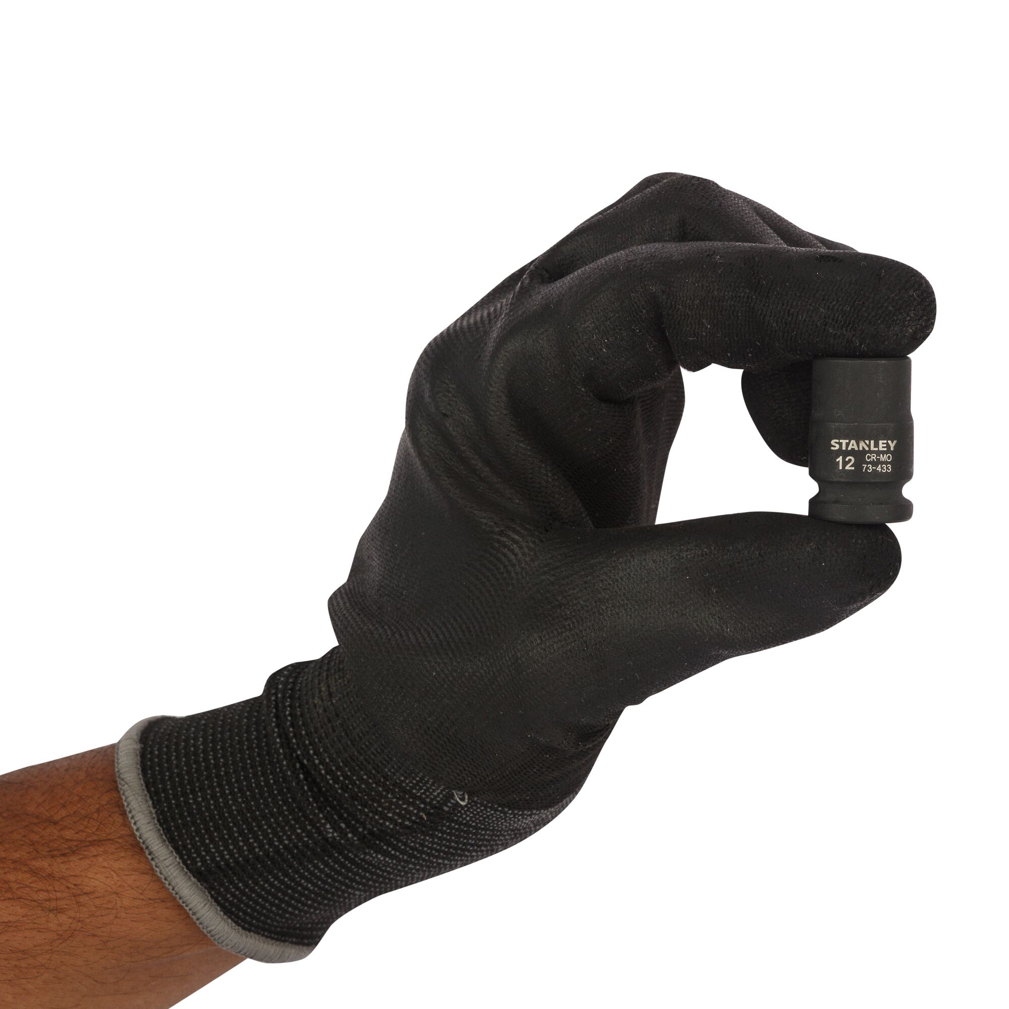Photo of a hand in black glove holding STANLEY STMT73433-8B socket, tool close-up on white background.