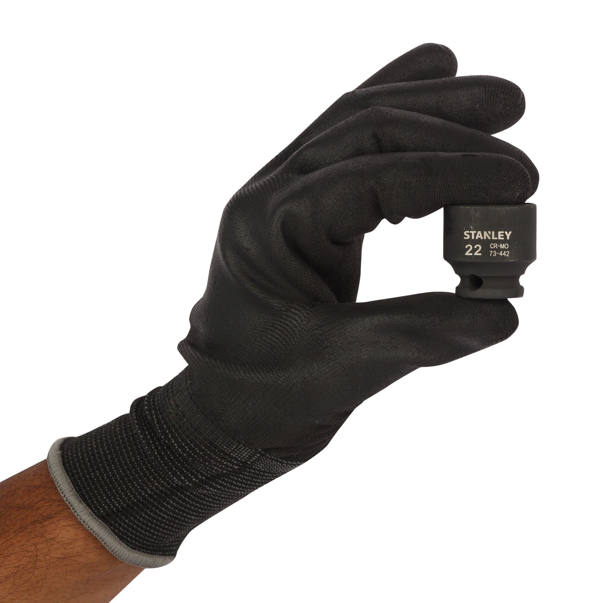 Photo of STANLEY STMT73442-8B socket held in gloved hand, black finish, product close-up.