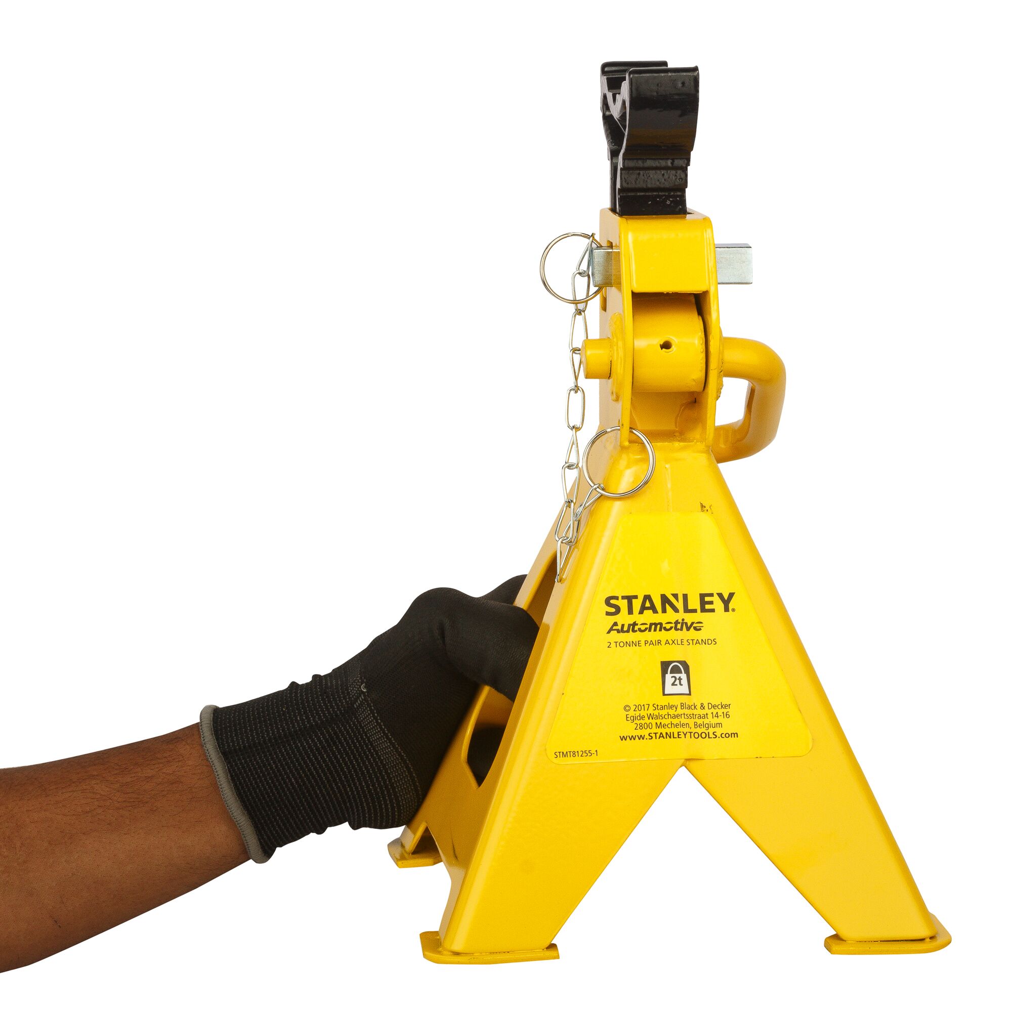 Photo of STANLEY STMT81255-1 yellow automotive axle stand with gloved hand, front angle, on white background.