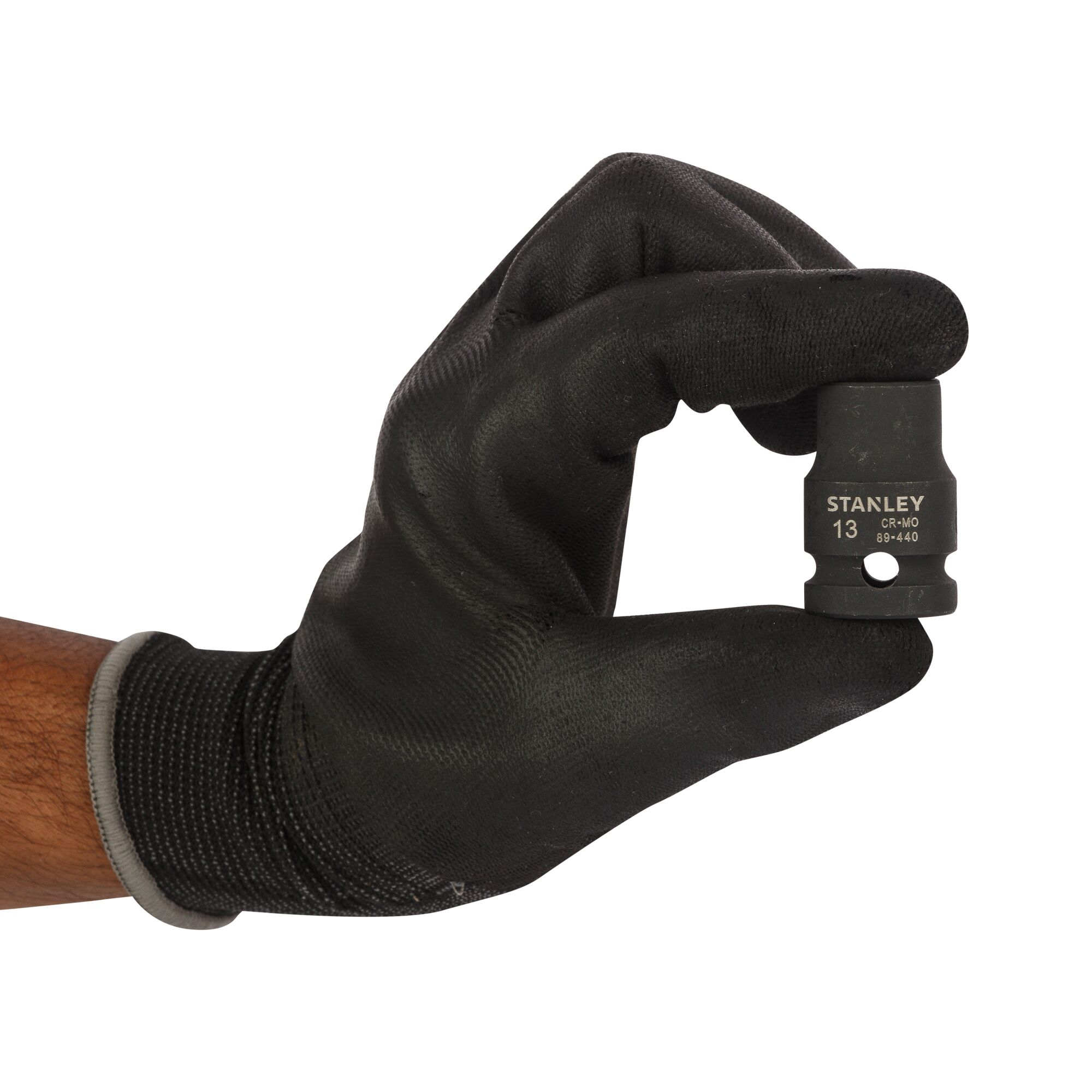 A gloved hand holding a Stanley 13mm socket tool, model STMT89440-8B, against a white background.