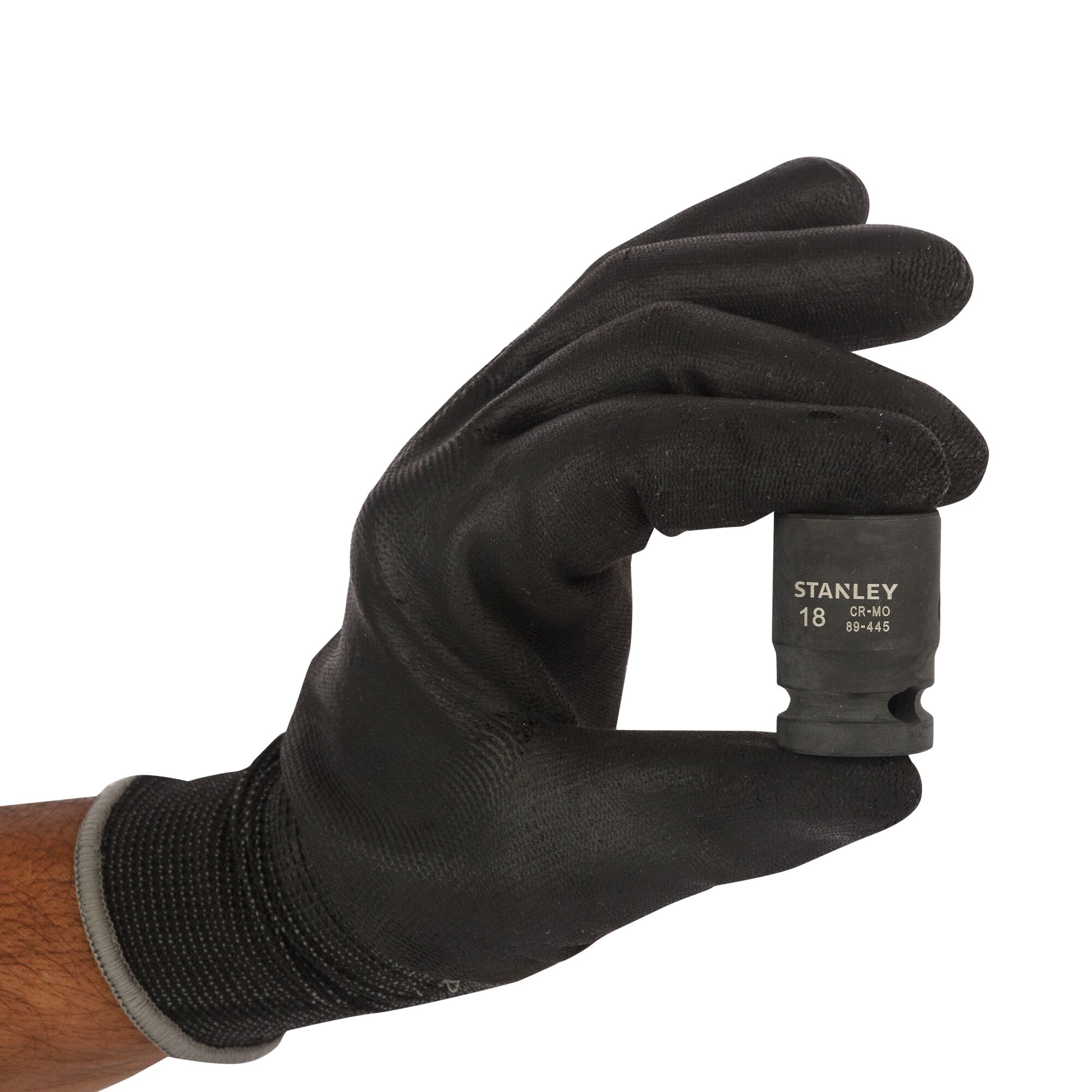 Photo of STANLEY STMT89445-8B socket held by a gloved hand, black finish, front angle.