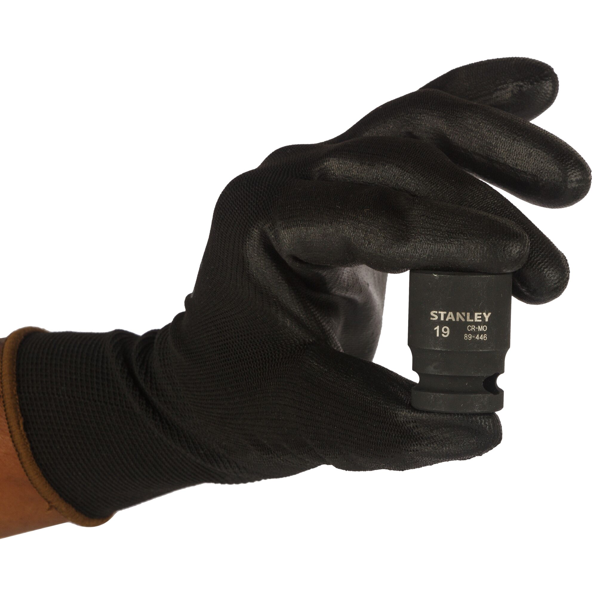 Photo of STANLEY STMT89446-8B socket held by gloved hand, black finish, photography category, front angle.