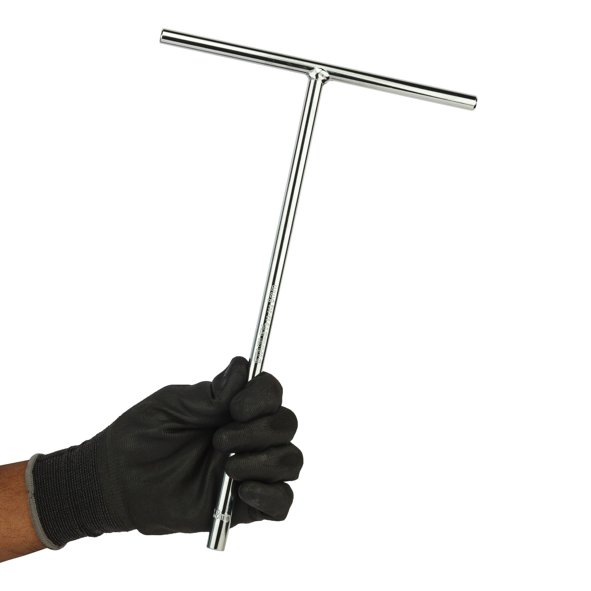 STANLEY STMT93302-8 T-shaped chrome socket wrench held by a gloved hand, side view.