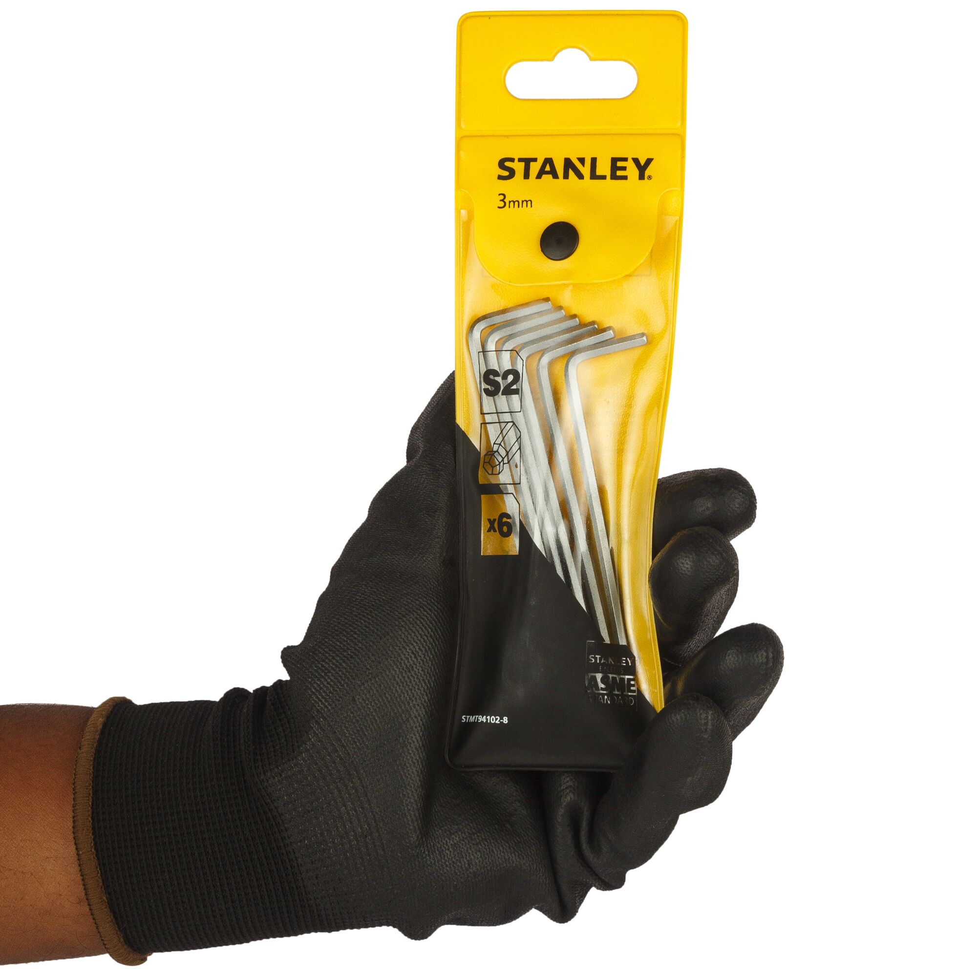 Photo of STANLEY STMT94102-8 3mm hex key set pack held in a gloved hand, six silver tools visible.