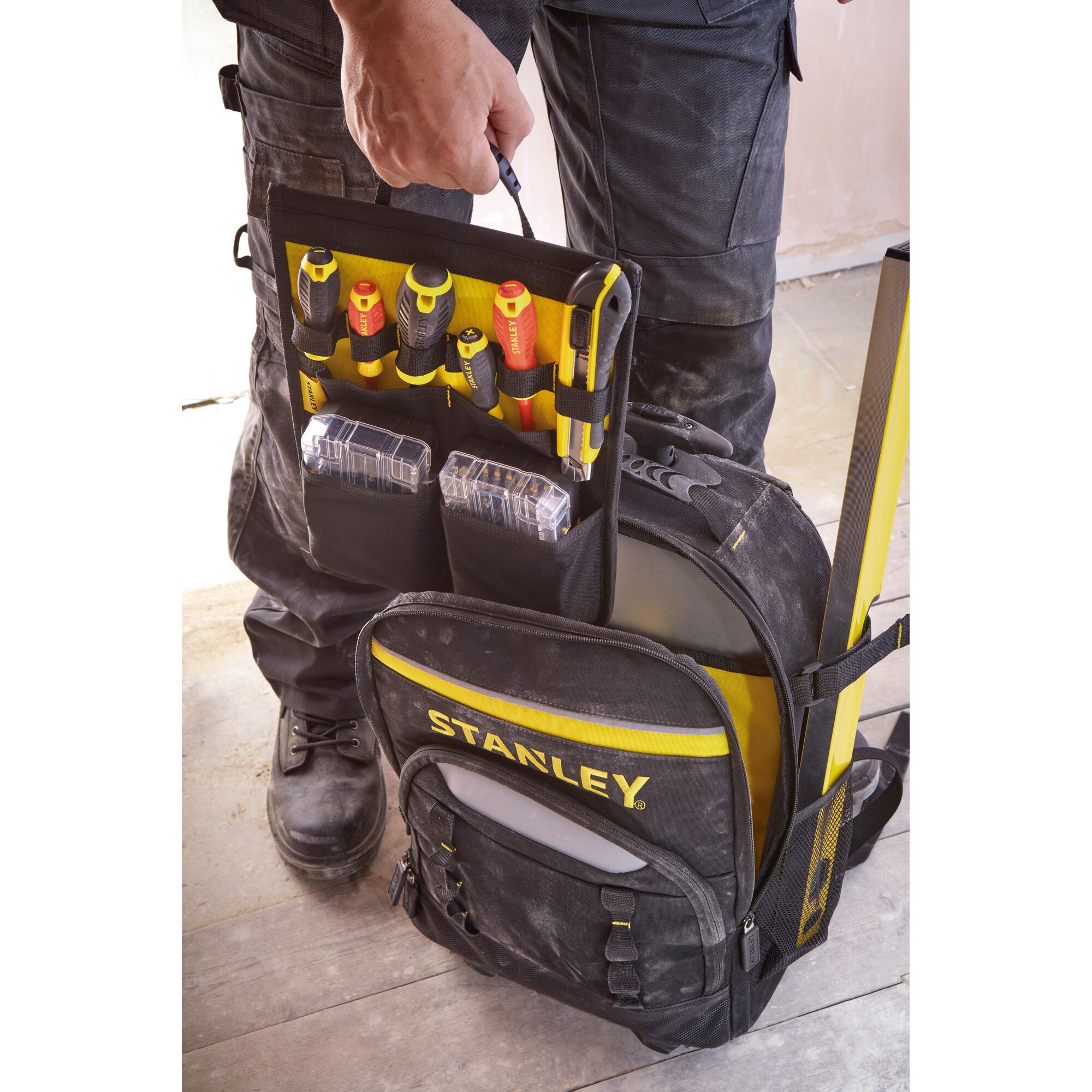 STANLEY STST83307-1 black and yellow tool backpack open, showing organized tools and boxes, front angle.
